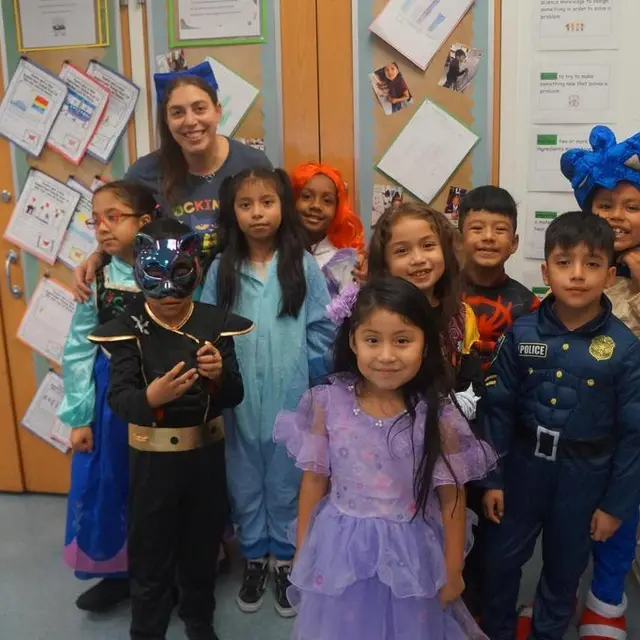 A kindergarten class in costumes with their teacher