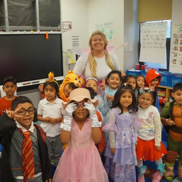 A class in costume, including a wizard in a striped scarf and a princess
