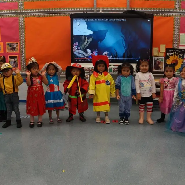 A young class standing in a line in their costumes
