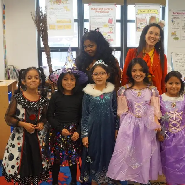 Scholars dressed as witches and princesses with their teacher