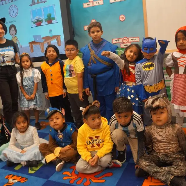 A class in costume, including superheroes and storybook characters