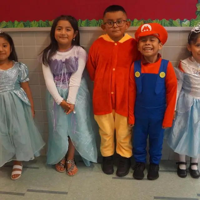 Scholars dressed as princesses and a plumber in red and blue