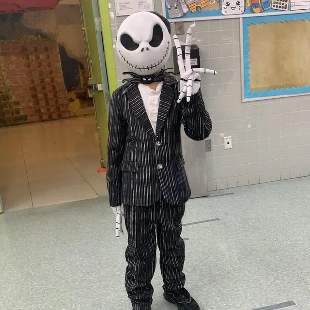 A scholar dressed as a skeleton in a pinstripe suit